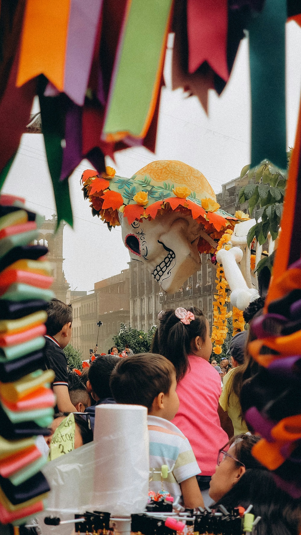 Families watching a colourful street festival parade