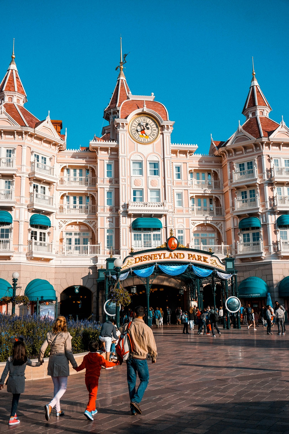 A family walking towards a theme park entrance