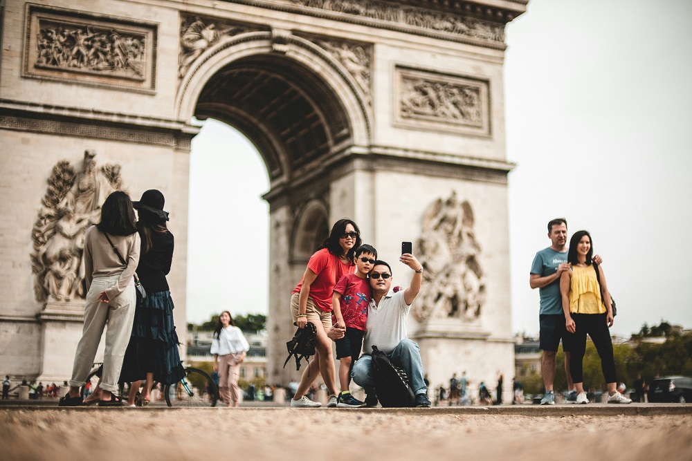 A family together at a busy landmark while travelling